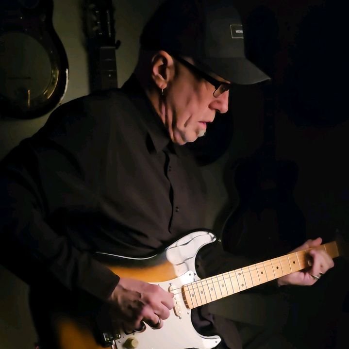 Ron Mears in the studio with a sunburst guitar